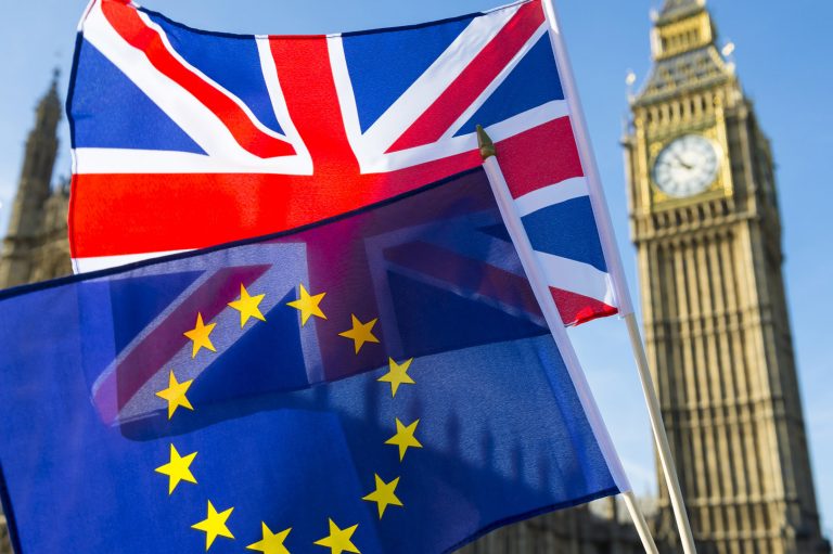 European Union and British Union Jack flag flying in front of Bi