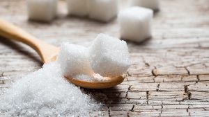 White,Sugar,In,Wood,Spoon,On,Wood,Table